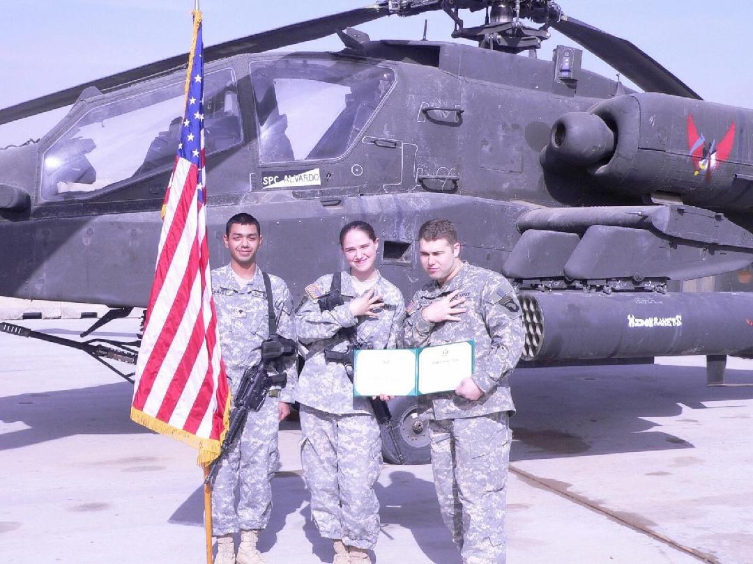 Award ceremony in front of Apache helicopter