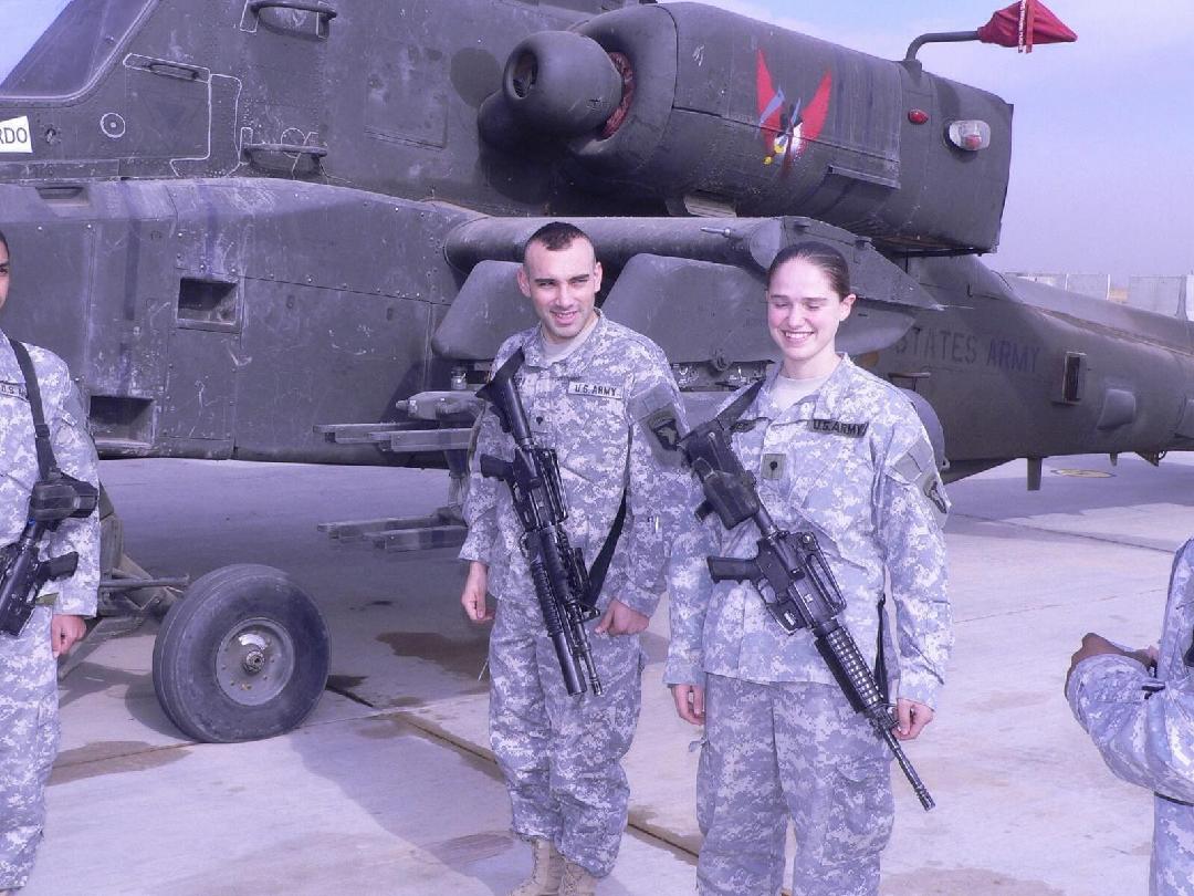 Tammy with crew by Apache helicopter